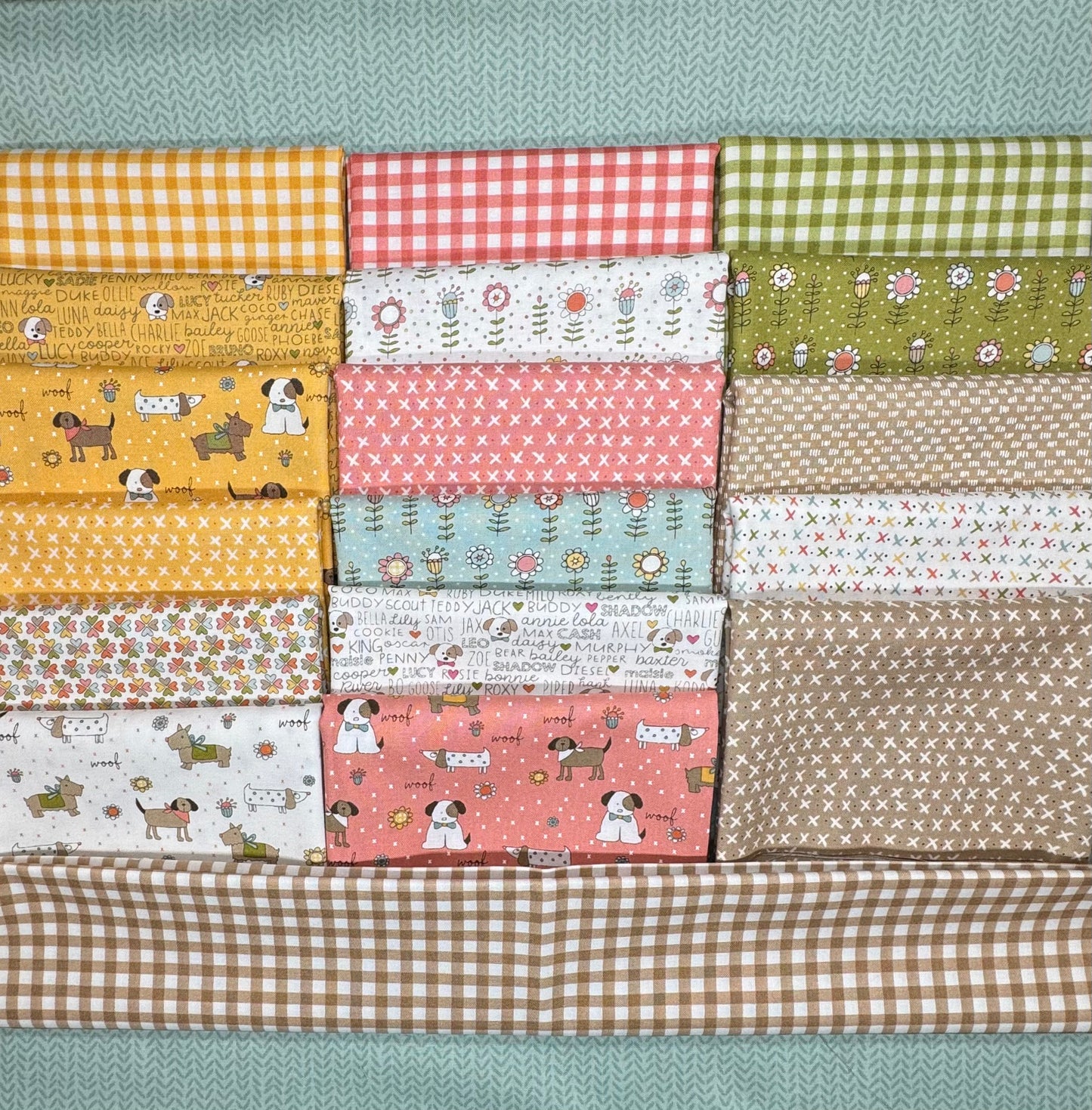 (Styled shot - sky background): Lucky quilt kit styled on sky blue background featuring Sweetwater's shamrock and daisy fabrics