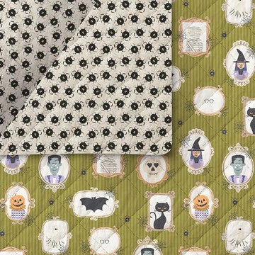 double sided fabric piece shown side by side: the left piece is off-white with a black spider pattern, and the right piece is olive green with Halloween-themed illustrations including pumpkins, a cat, a witch, a skeleton, and framed portraits.