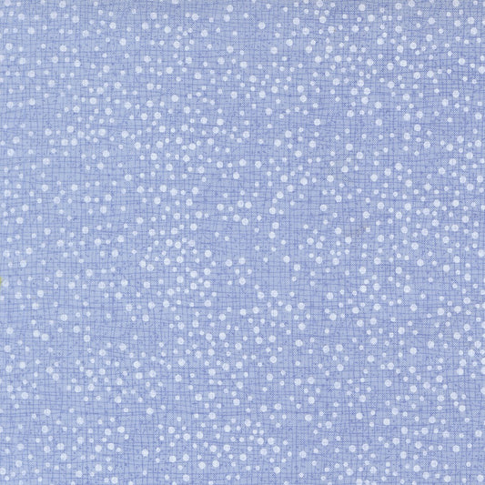 Light blue fabric with a white hand-drawn polka dot pattern on a fine grid background.