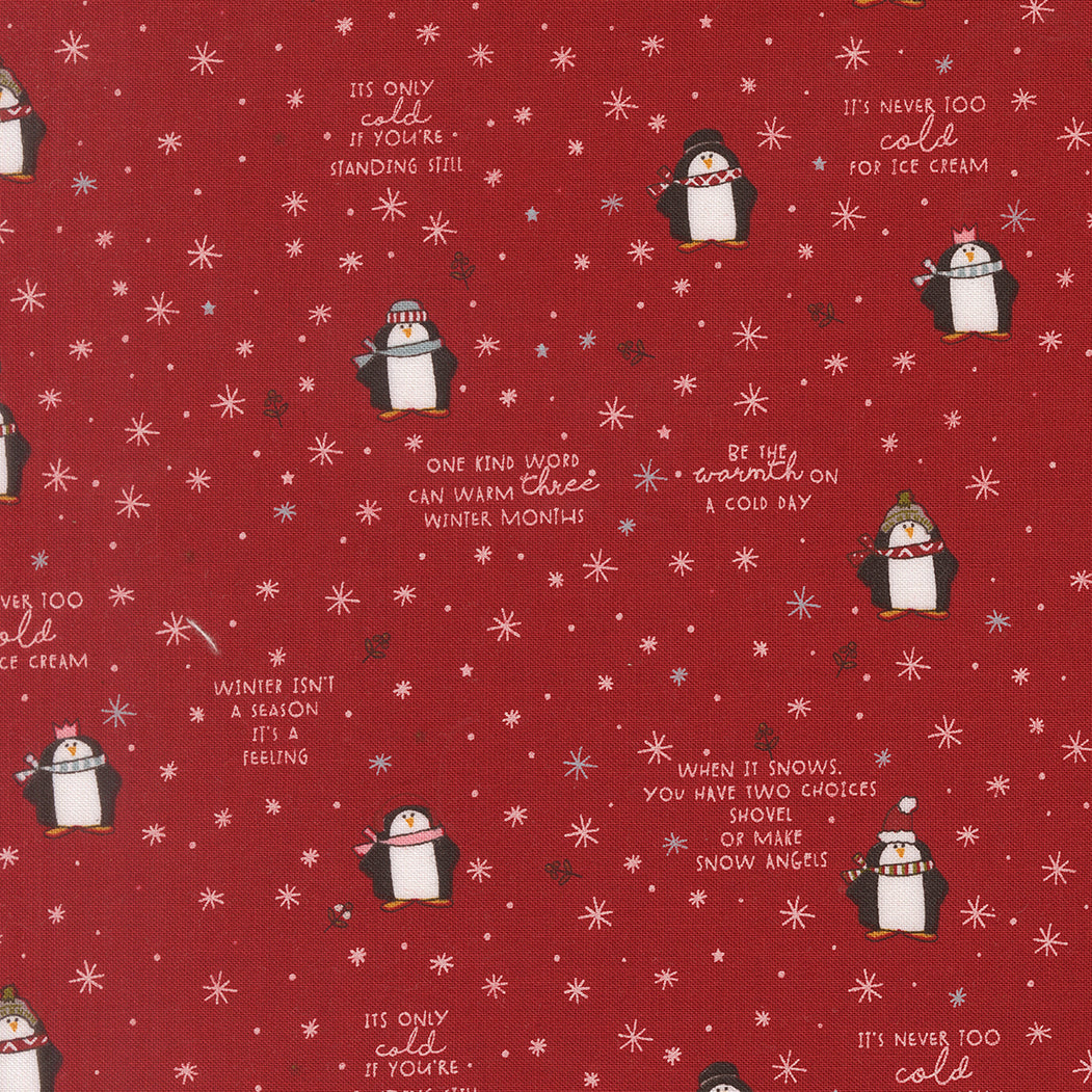 Red fabric with penguin illustrations and winter-themed text on a red background