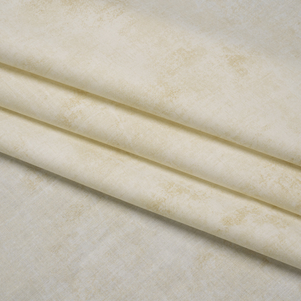 Cream-colored fabric with a subtle distressed, mottled texture, shown folded to display its drape and pattern.