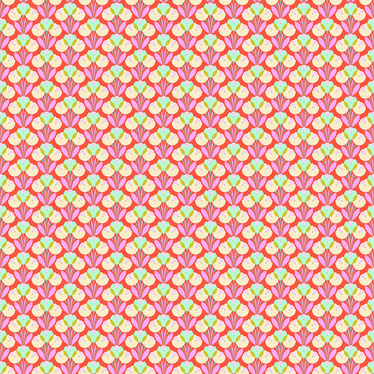 Coral fabric with repeating geometric floral pattern in cream, green, and lavender tones forming a symmetrical design.