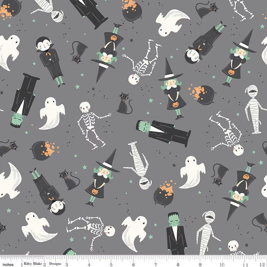 Halloween-themed fabric with ghosts, skeletons, and other characters on a gray background.