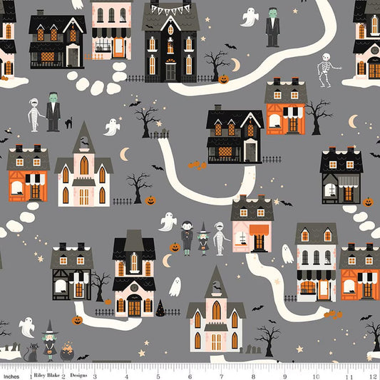 Halloween-themed fabric with houses, ghosts, and pumpkins on a gray background.
