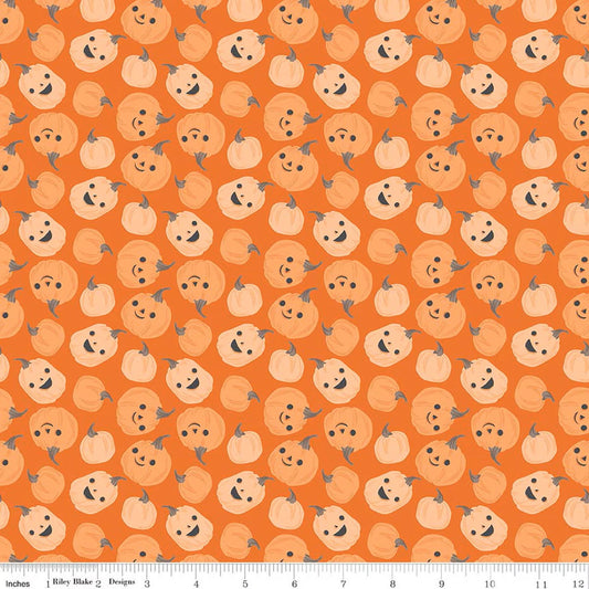 Pattern of smiling pumpkins on an orange background with a ruler at the bottom.