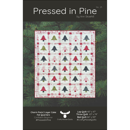Pressed in Pine quilt pattern by Ann Skaehill for Crafty Moose Quilts — Christmas tree quilt in red, green, and navy on cream background
