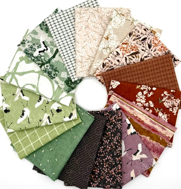 Soar half-yard bundle by Katrina Rocella, fanned out with bird, floral and geometric prints in greens, pinks and rust.
