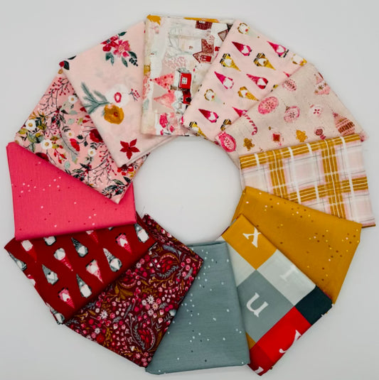 Adventale fabric bundle by Katarina Roccella for Art Gallery Fabrics - 12 half-yard cuts (0.457m each) of 100% premium cotton featuring festive Christmas prints in pinks, reds, golds, and spruce