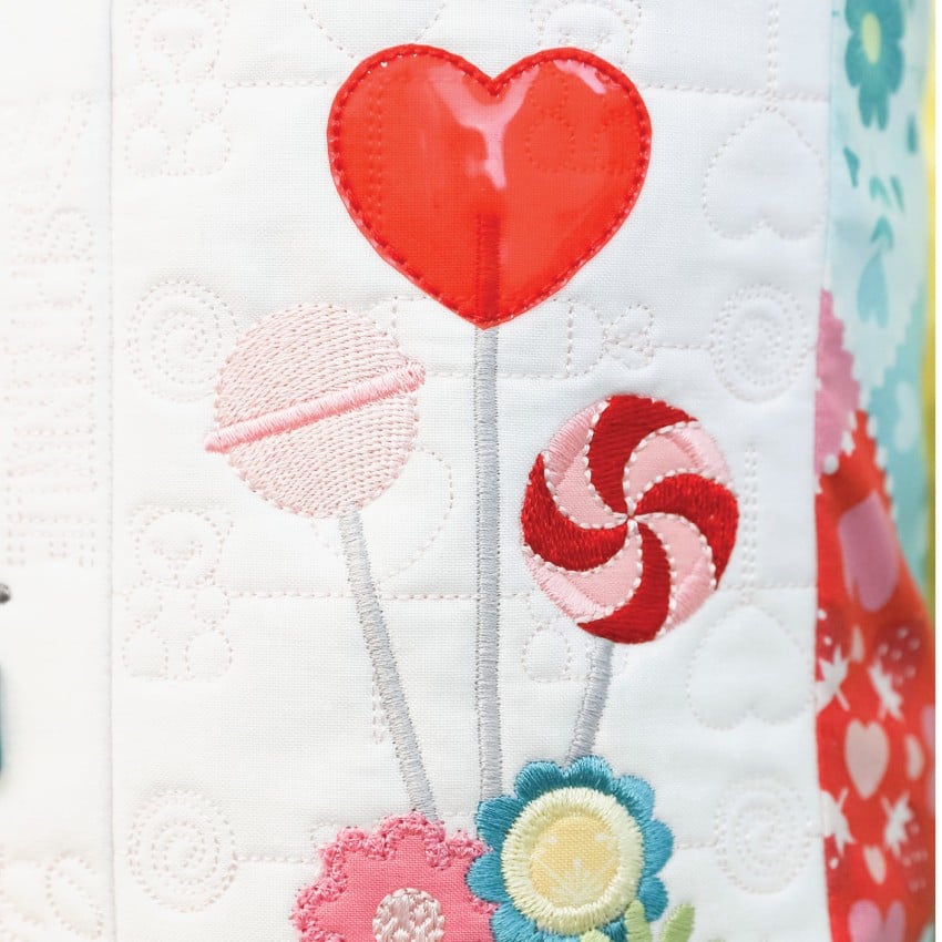 (Detail/contents): Close-up of Kimberbell Sweetheart Street bench pillow embellishments including buttons and specialty trims