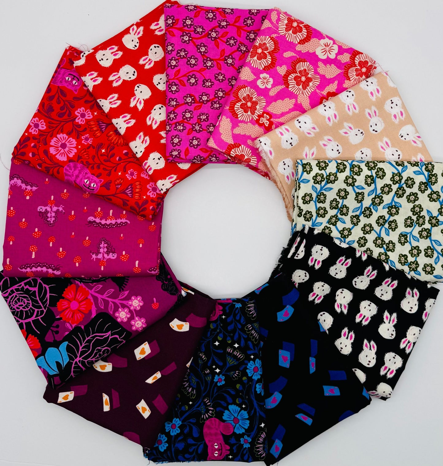 Hello Alice fabric bundle by Sarah Watts for Ruby Star Society - 12 half-yard cuts (0.457m each) of 100% cotton quilting fabric featuring whimsical Alice in Wonderland prints